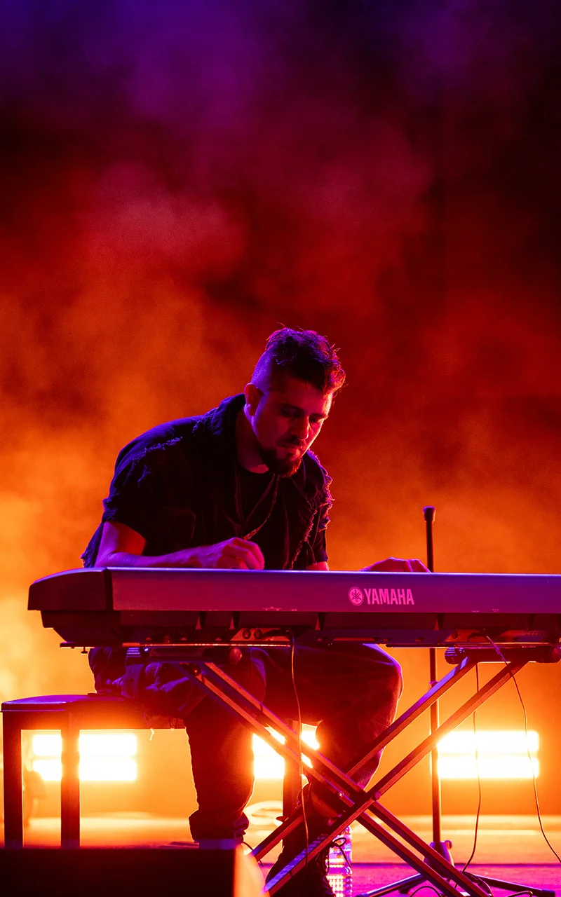 male lead singer on keyboard photograph