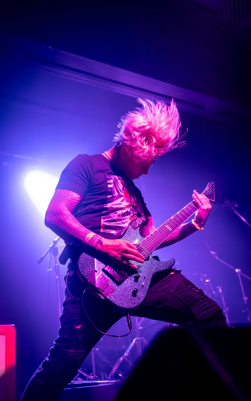 male guitar player at concert photograph