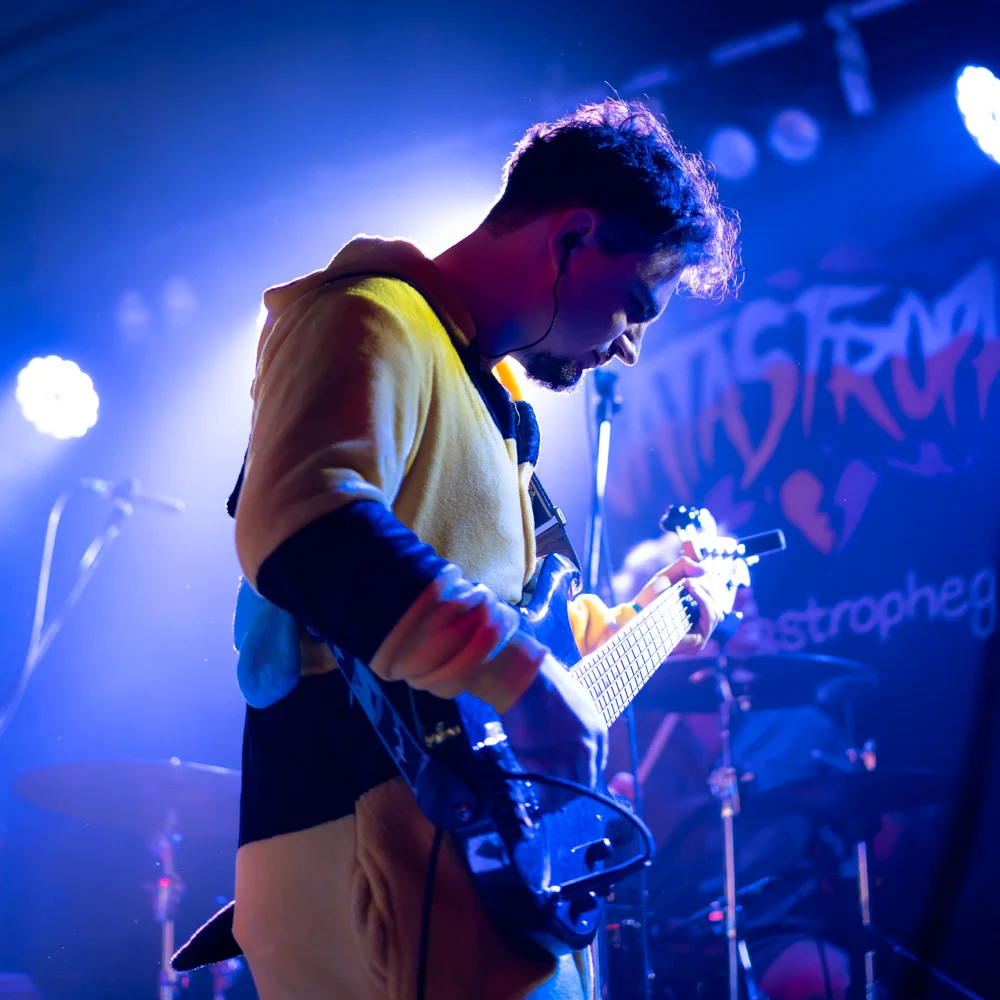 bass guitar player close up photograph