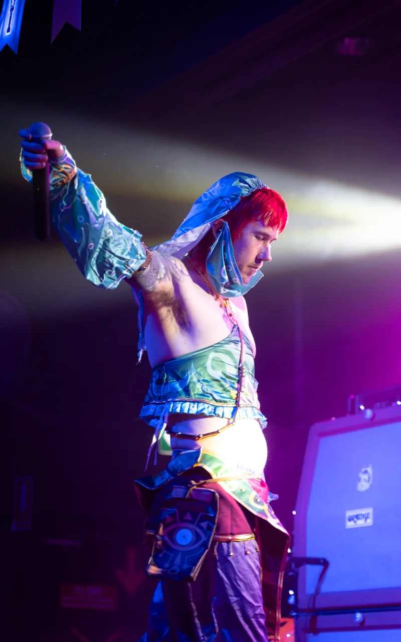 male singer in costume striking pose photograph
