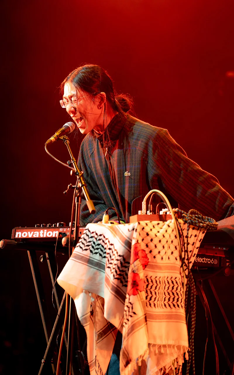 male keyboard player singing into microphone photograph