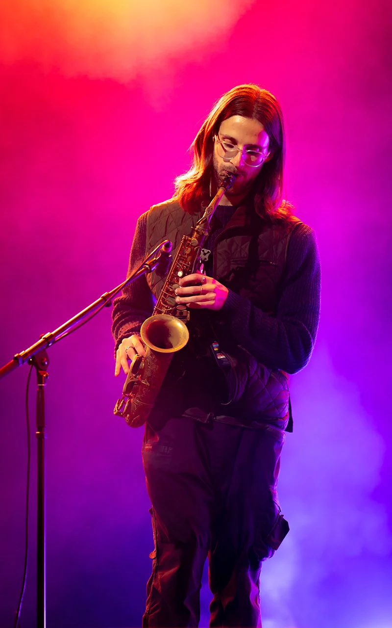 saxaphone player in colorful fog on stage photograph